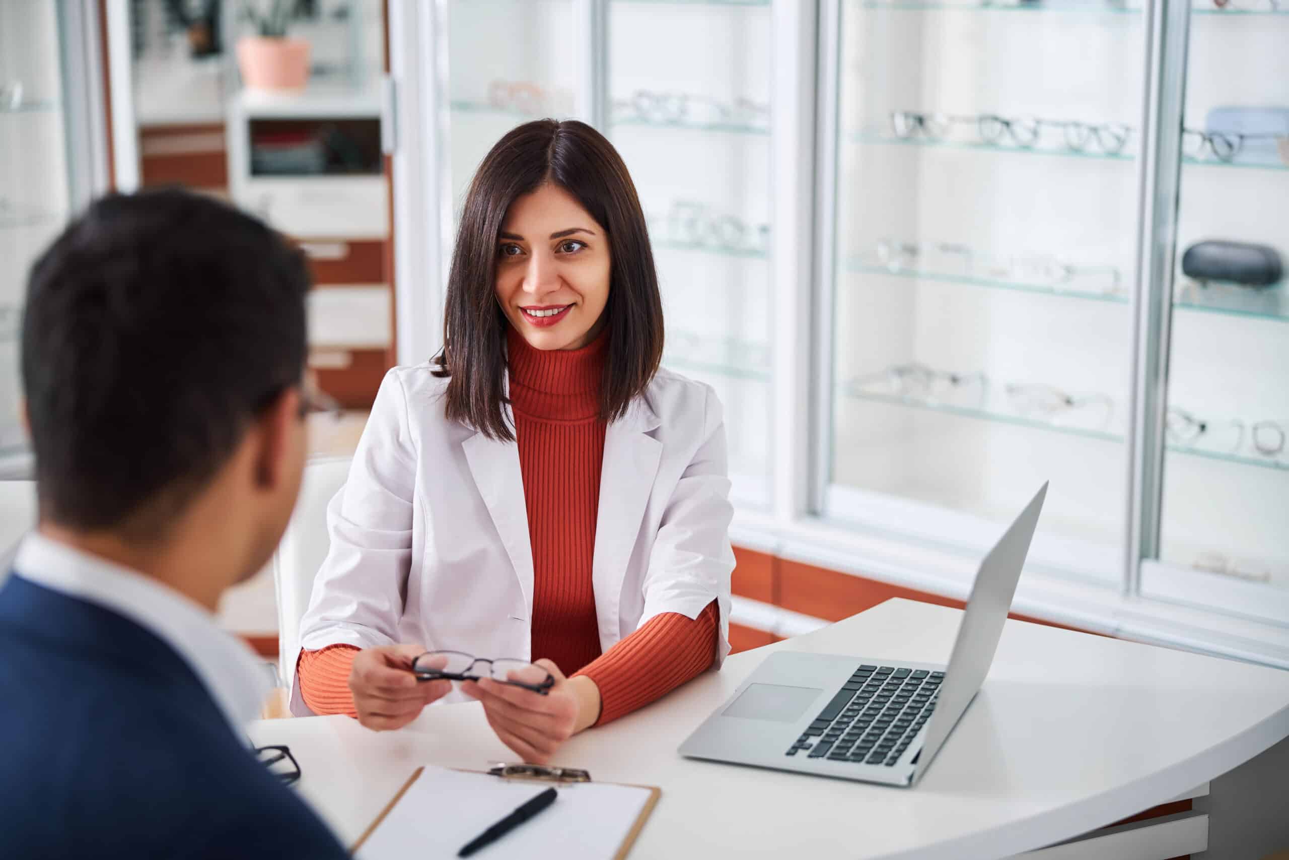 female optometrist showing the eyewear to her client