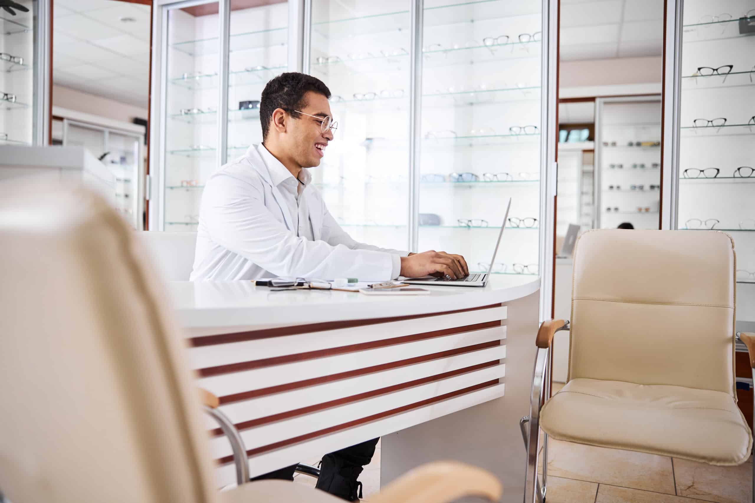 eye-doctor-sitting-in-front-of-laptop eye doctor sitting in front of laptop