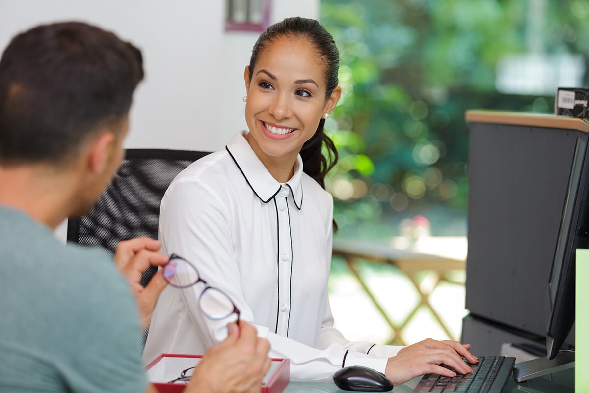 eye doctor sitting in front of laptop