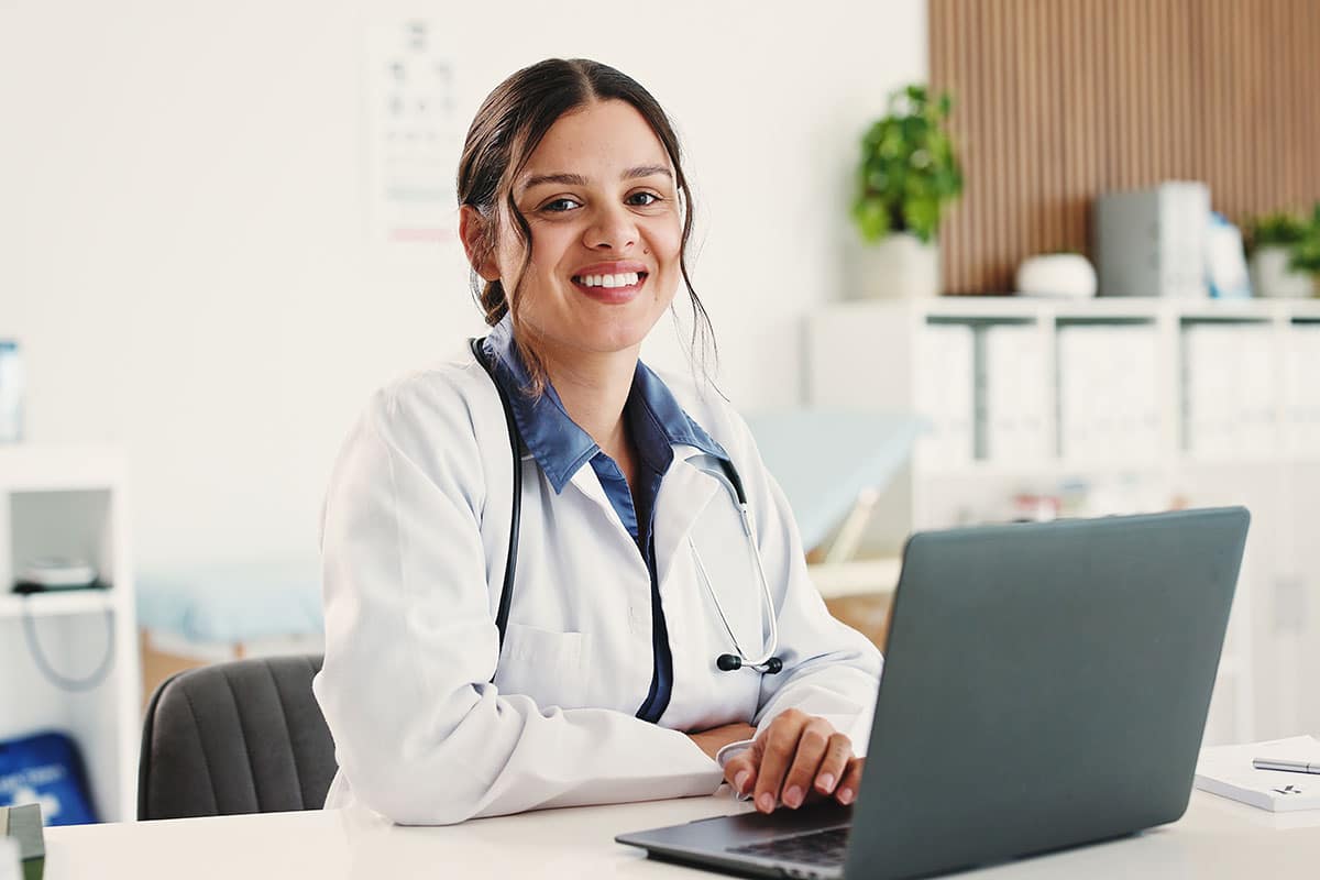 eye doctor sitting in front of laptop