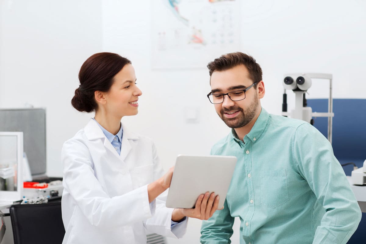 eye doctor sitting in front of laptop